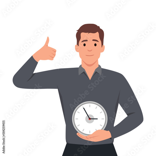 Smiling man in uniform holding clock in hands showing thumb up. Happy male worker with watch care about time management and deadline