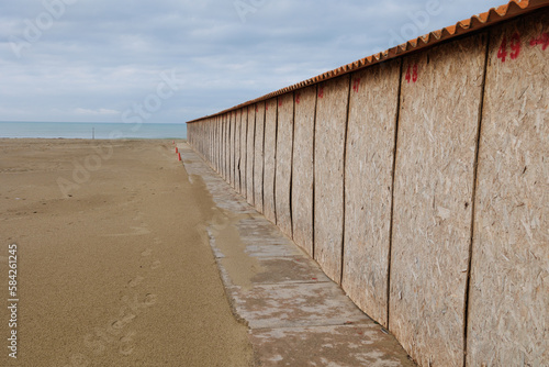 Deserted and Desolate Beach in Winter Time, Sealed Cabins with Wooden Boards