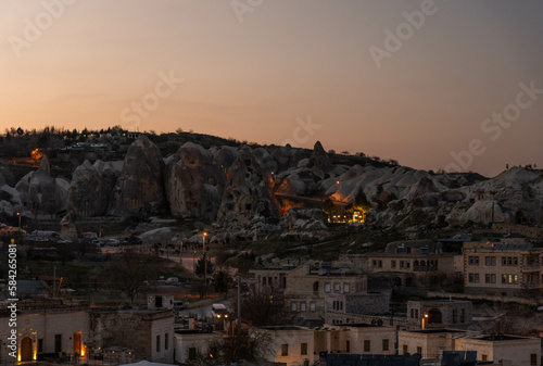 Sunset landscape of Cappadocia town with lights and houses, Turkey