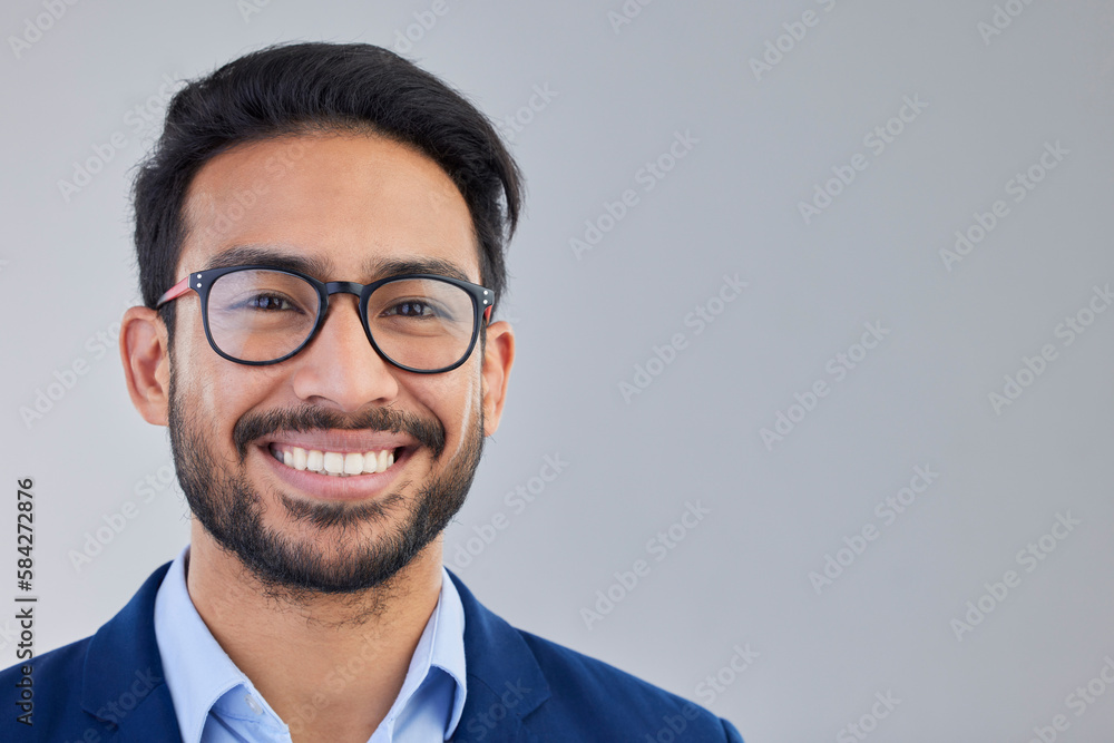 Portrait, happy and excited businessman in studio with glasses, smile and confident on grey background space. Face, isolated and young mexican entrepreneur pose empowered, professional and handsome Portrait, happy and excited businessman in studio with glasses, smile and confident on grey background space. Face, isolated and young mexican entrepreneur pose empowered, professional and handsome