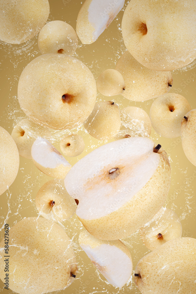 Creative layout made from Fresh Chinese pear and water Splashing on a yellow background Creative layout made from Fresh Chinese pear and water Splashing on a yellow background