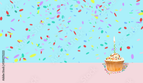 Colorful cupcake with single birthday candle on festive background with confetti. Empty space for text