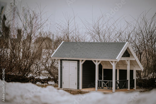 Home concepts, Miniature wooden house model with blurred green background. Selective soft focus.