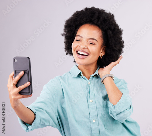 Black woman, selfie and afro with smile in studio with technology, social media and funny by gray background. Girl, model and influencer with profile picture, photography and blog post with happiness