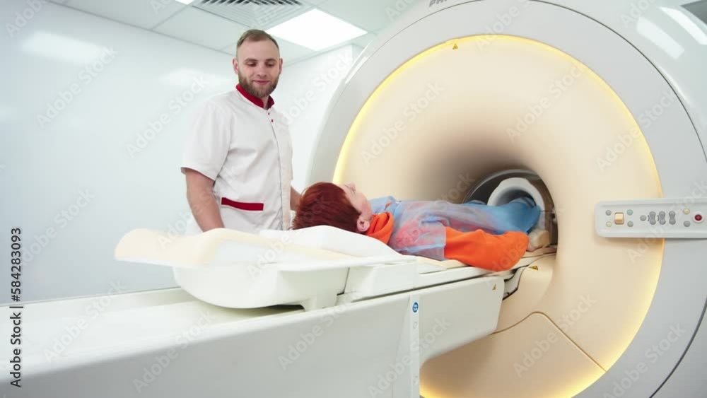 A doctor performs an MRI on a patient in the clinic. The girl lies in an MRI machine. Magnetic resonance imaging in the study of the knee joint. Modern technologies in medicine. A doctor performs an MRI on a patient in the clinic. The girl lies in an MRI machine. Magnetic resonance imaging in the study of the knee joint. Modern technologies in medicine.
