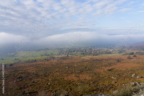 Strange clouds sit over a foggy Hope Valley in the Derbyshire Peak District.
