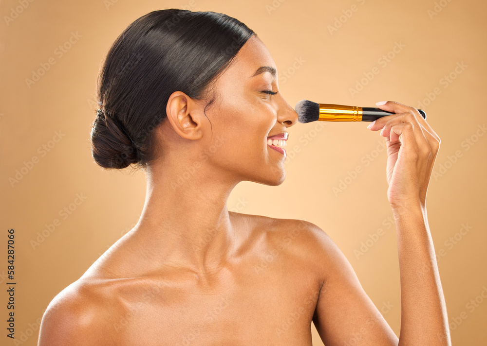 Fototapeta premium Indian woman, beauty and brush for makeup, happy with cosmetic tools and glow and face profile on studio background. Female, smile and cosmetology, apply foundation or powder with self care