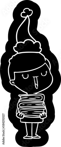 cartoon icon of a happy boy with stack of books wearing santa hat