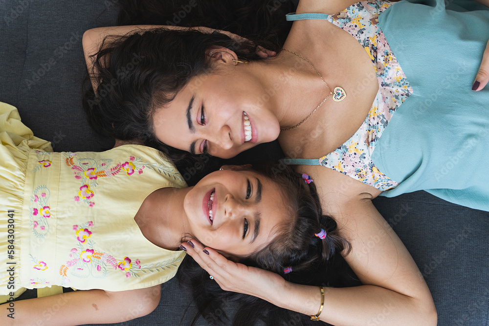 Overhead perspective portrait of mother and daughter laughing