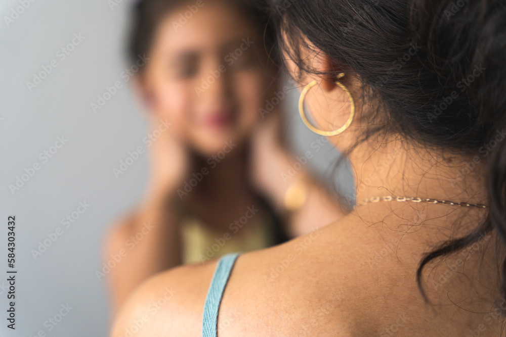 Mom from behind caresses the face of her sweet girl while she is happy for this gesture Mom from behind caresses the face of her sweet girl while she is happy for this gesture