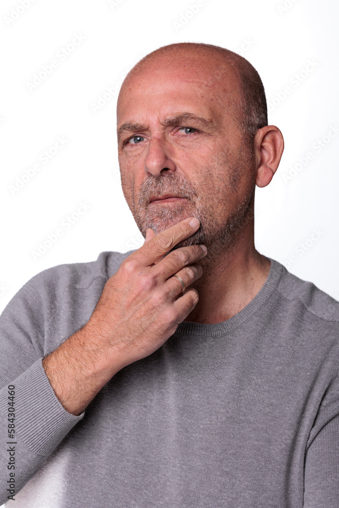 Close up headshot confident serious concentrated man over 50 looking at camera studio portrait, isolated on white studio background Close up headshot confident serious concentrated man over 50 looking at camera studio portrait, isolated on white studio background