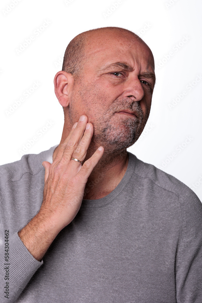 Close up headshot confident serious concentrated man over 50 looking at camera studio portrait, isolated on white studio background Close up headshot confident serious concentrated man over 50 looking at camera studio portrait, isolated on white studio background