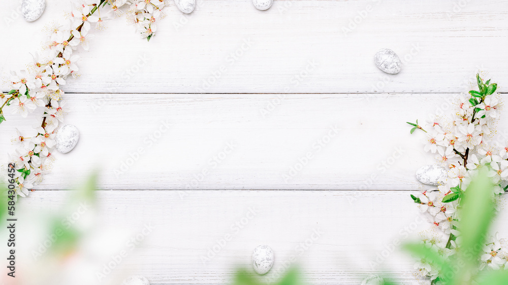 Fototapeta premium Easter background wood. Sakura blossom flower, white happy easter eggs on wood spring background. Easter design. Top view. Flat lay.