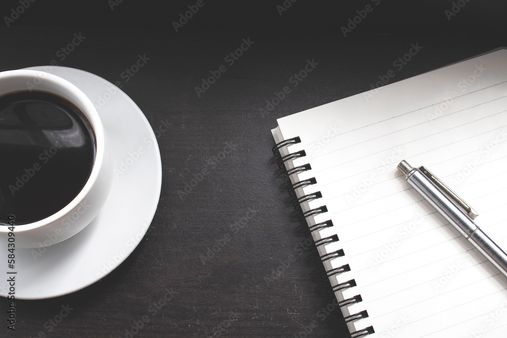 Cup of coffee and blank notebook on the wood Cup of coffee and blank notebook on the wood