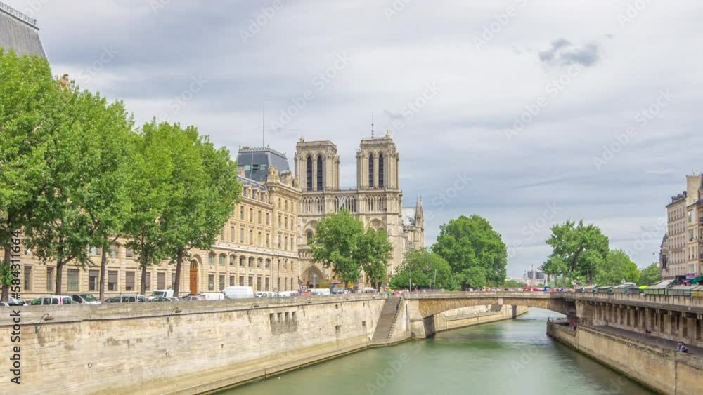Notre Dame de Paris and Seine waterfront timelapse hyperlapse. One of the most famous symbols of Paris. Petit Bridge - Cardinal Lustiger and Police Department. View from Bridge of Saint-Michel Notre Dame de Paris and Seine waterfront timelapse hyperlapse. One of the most famous symbols of Paris. Petit Bridge - Cardinal Lustiger and Police Department. View from Bridge of Saint-Michel