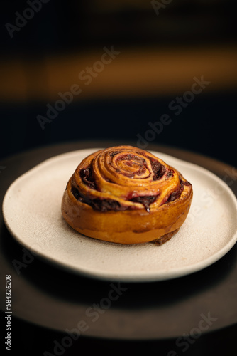 Close-up, bakery - delicious bun with jam on a rotating surface