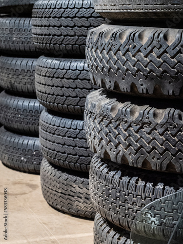 A collection of car tyres stacked.