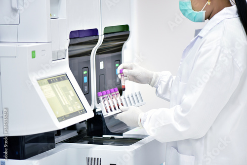 Female medical technologist using diagnostic tools in cancer hospital in Thailand