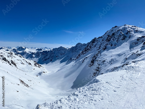 Alpine valley, snowy mountains in Switzerland. Panoramic view over the mountains during winter. Ski area Arosa, Switzerland. Winter sports in the snowy mountains.