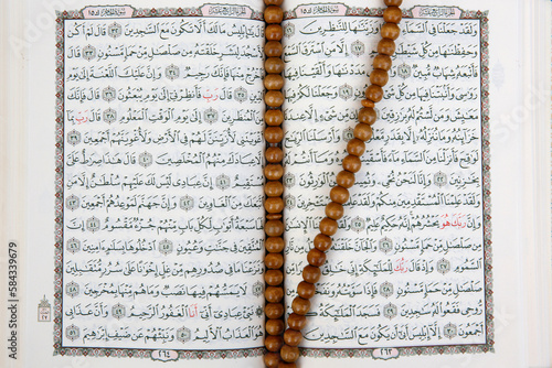 Open Kuran and prayer beads. France.