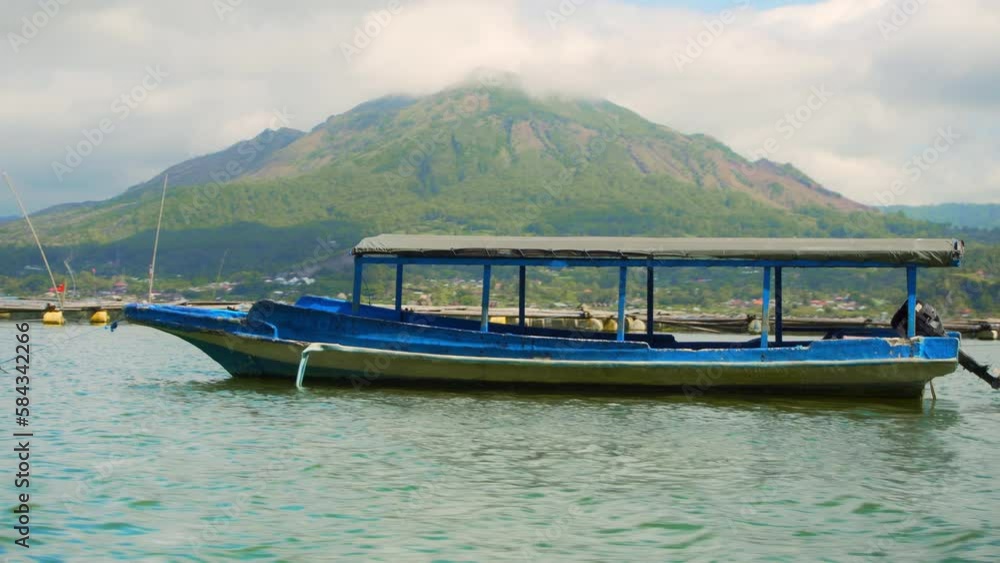 blue Balinese boats on the lake for crossing and fishing stand in the water. blue Balinese boats on the lake for crossing and fishing stand in the water.