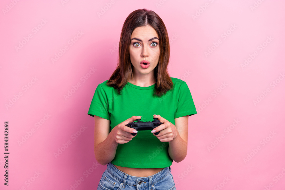 Photo of impressed pretty lady pouted lips arms hold controller playing games isolated on pink color background - obrazy, fototapety, plakaty 