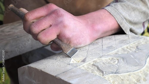 Closeup of skilled stonemason crafting a stone