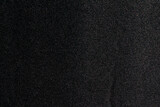 Black paper fabric texture background. Dark blank surface for designs.