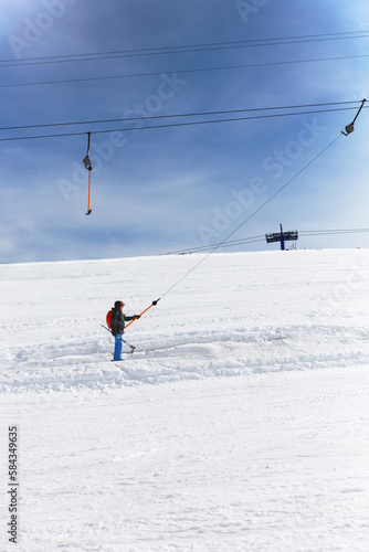 Skier On Ski Lift And On Slope