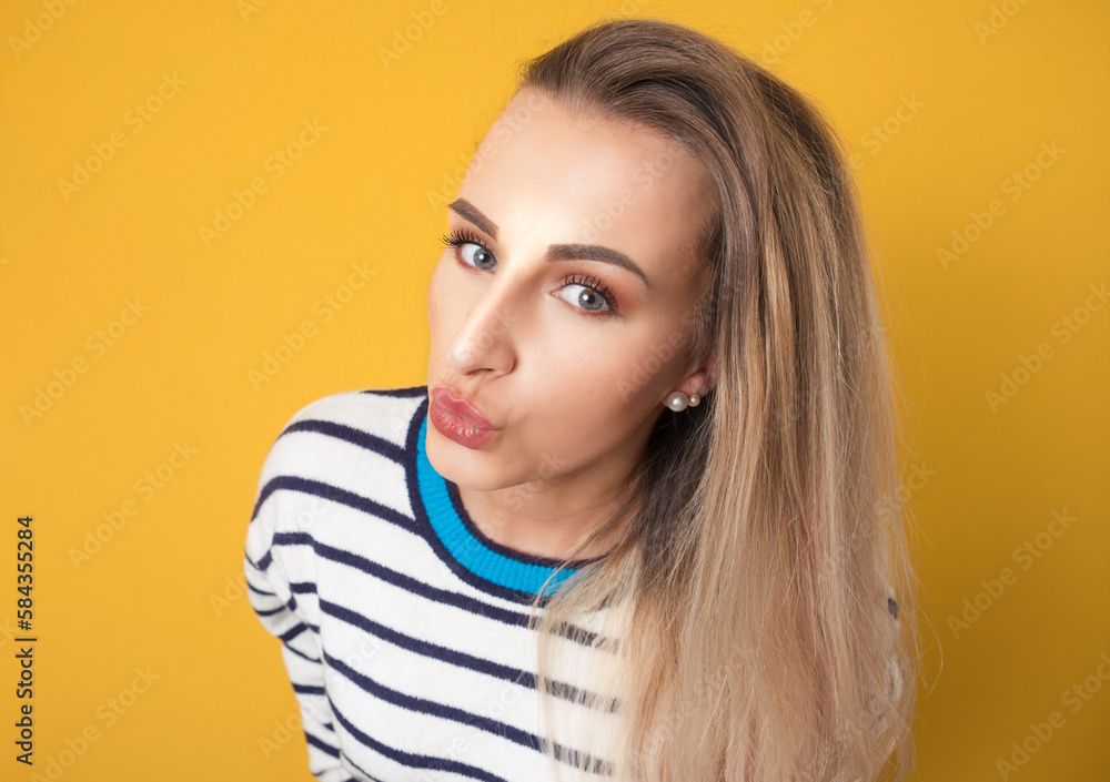 Silly woman staring at you, isolated on yellow background. Funny girl stares at camera Silly woman staring at you, isolated on yellow background. Funny girl stares at camera