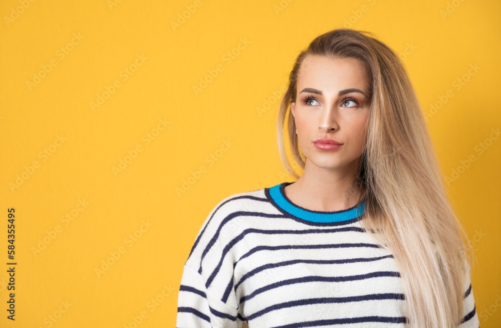 Consider woman thinking while looking up to blank space, isolated on yellow background. Close-up of pensive girl Consider woman thinking while looking up to blank space, isolated on yellow background. Close-up of pensive girl