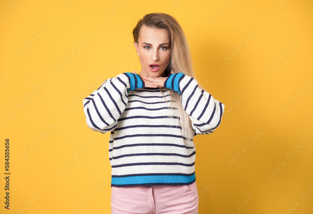 Surprised gorgeous young woman gesturing, isolated on yellow background. Surprise female person. Amazed beautiful girl Surprised gorgeous young woman gesturing, isolated on yellow background. Surprise female person. Amazed beautiful girl