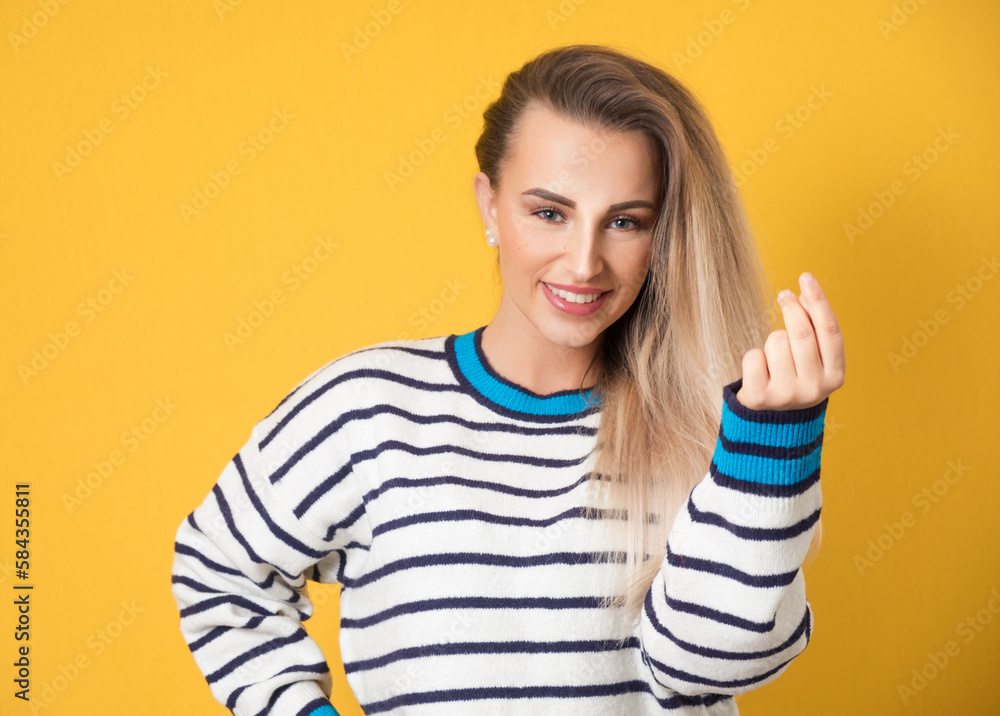 Young woman snapping fingers, isolated on yellow background. One beautiful girl gesturing click Young woman snapping fingers, isolated on yellow background. One beautiful girl gesturing click