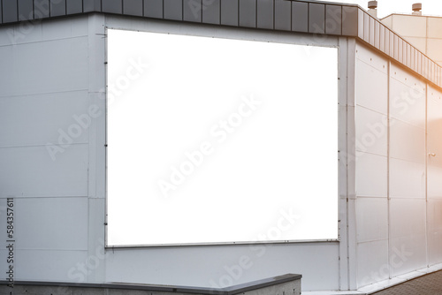 Fototapeta Naklejka Na Ścianę i Meble -  White blank information signboard mounted on supermarket wall outside. Shopping and advertising concept.
