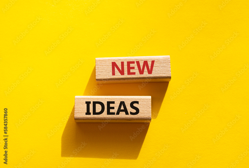 New ideas symbol. Concept word New ideas on wooden blocks. Beautiful yellow background. Business and New ideas concept. Copy space New ideas symbol. Concept word New ideas on wooden blocks. Beautiful yellow background. Business and New ideas concept. Copy space