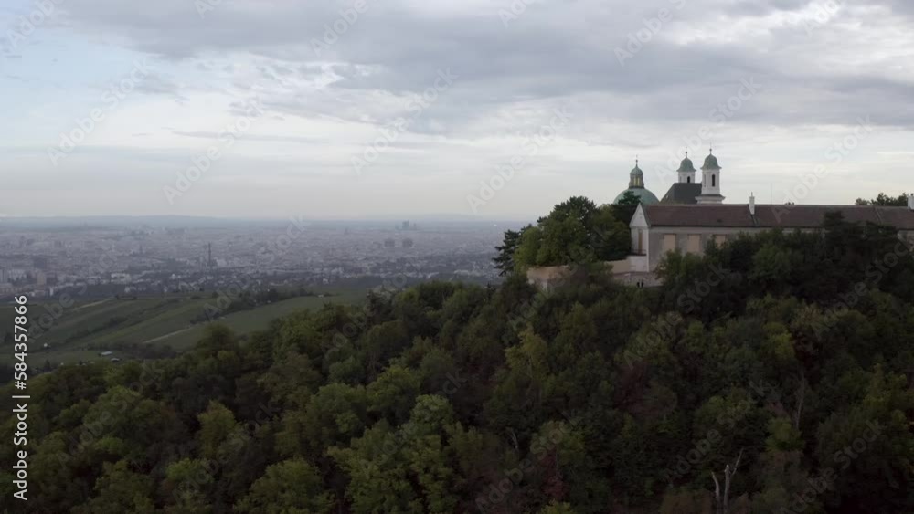 Beautiful view of an ancient building on a hill with large trees on a cloudy day Beautiful view of an ancient building on a hill with large trees on a cloudy day