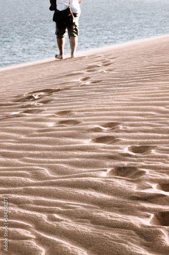 Hiker in the dunes of Maspalomas, Gran Canaria, Canary Islands, Spain. photo