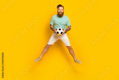 Full body photo of overjoyed football fan support favorite club jumping goalkeeper fifa world cup championship isolated on yellow color background