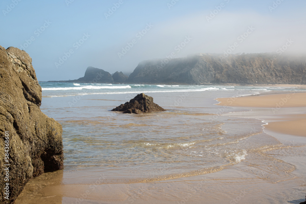 Sea and Rocks With Mist at Odeceixe Beach; Algarve; Portugal