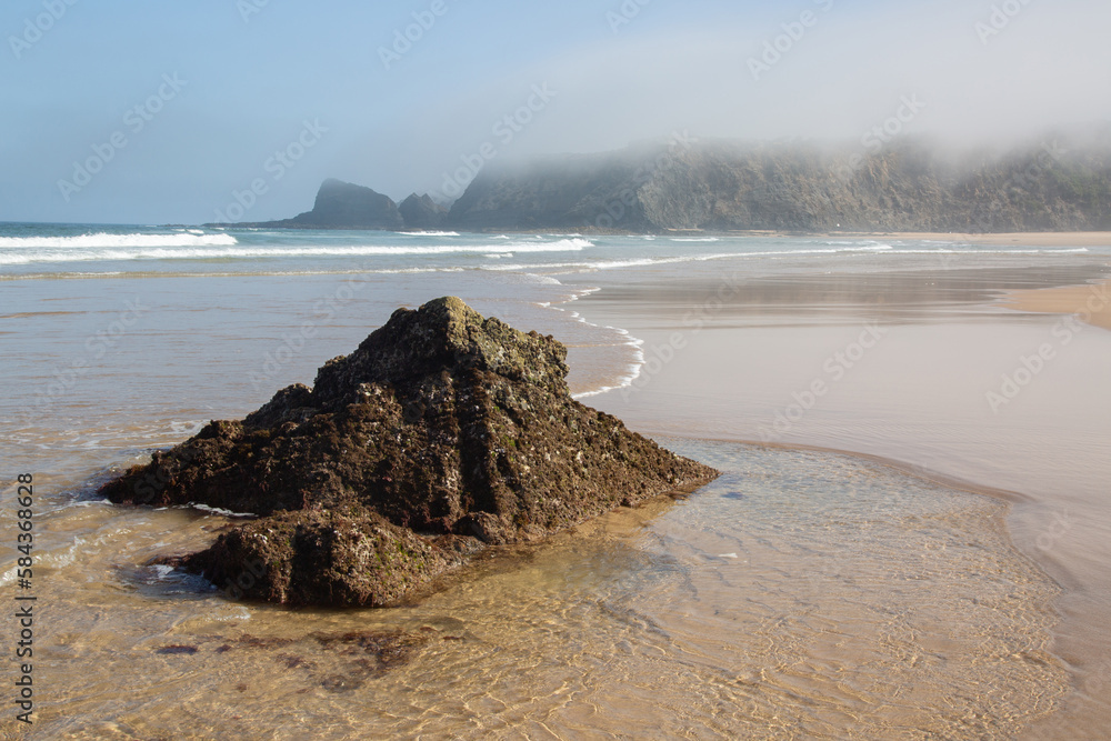 Sea, Cliffs and Rocks With Mist at Odeceixe Beach; Algarve; Portugal