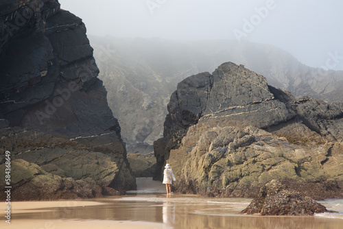 Figure with Sea, Cliffs and Rocks With Mist at Odeceixe Beach; Algarve; Portugal