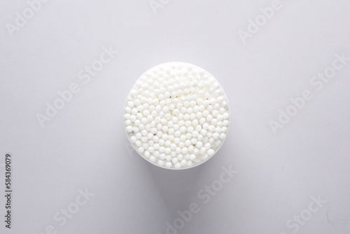 Top view cotton swabs in a round box, gray background