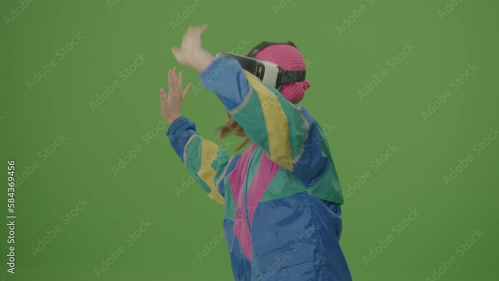 Green Screen. Girl of '80-'90s Style Wearing Virtual Reality Headset Gestures in Augmented Reality. VR Transformation. Concept of Cyberspace of the Fifth Dimension, Digital Worlds, Virtual Adventure Green Screen. Girl of '80-'90s Style Wearing Virtual Reality Headset Gestures in Augmented Reality. VR Transformation. Concept of Cyberspace of the Fifth Dimension, Digital Worlds, Virtual Adventure