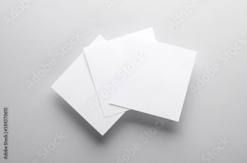 White empty square memo pieces of paper on gray background. Template for design. Top view