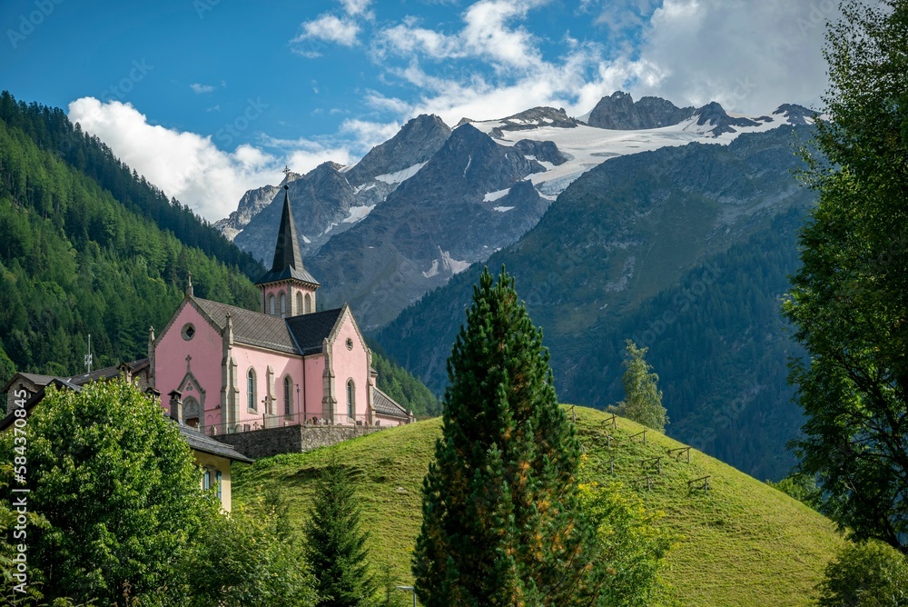 The Trient Eglise Rose church in the Swiss Alps with a green landscape