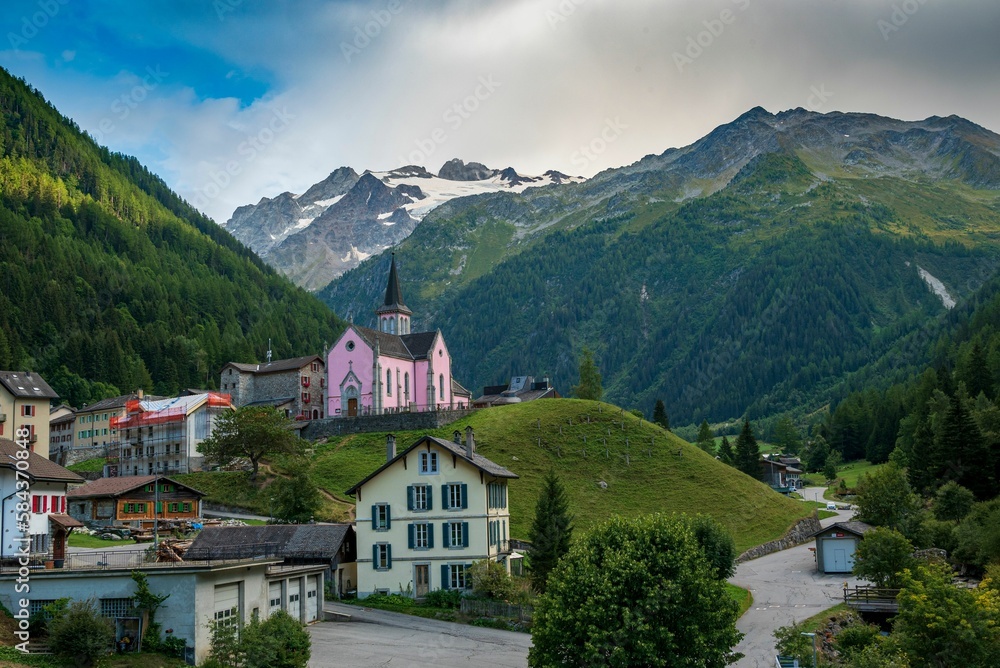 The Trient Eglise Rose church in the Swiss Alps with a green landscape