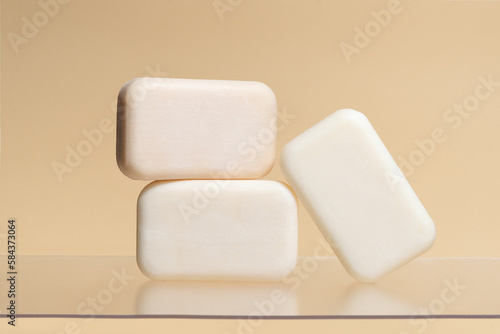 Pieces of plain natural soap on a beige isolated background. Image for your design
