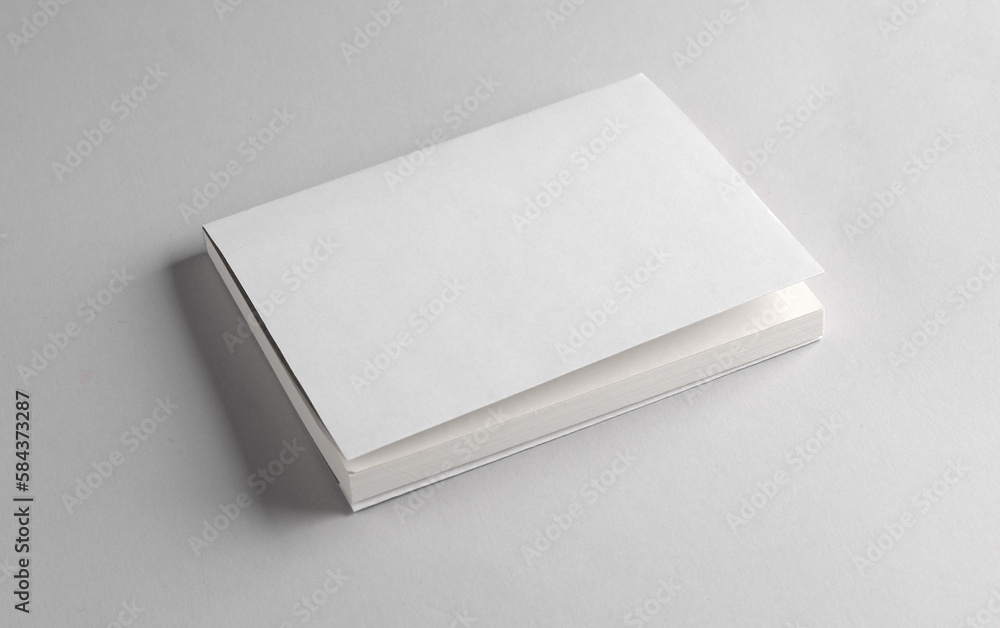 Book or notepad mockup with white cover on gray background. Template for design Book or notepad mockup with white cover on gray background. Template for design