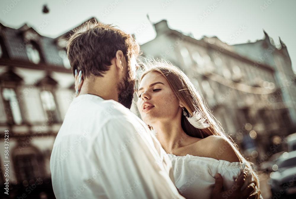 Romantic portrait of a couple in love in the city at bright day