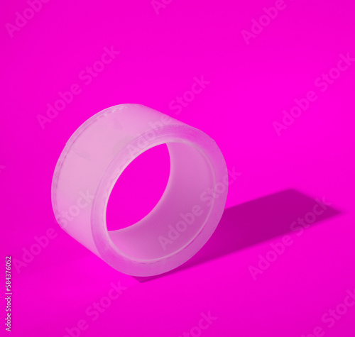 Transparent duct tape skein on pink background